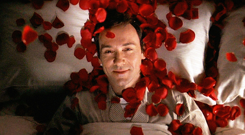 The movie "American Beauty", directed by Sam Mendes and written by Alan Ball. Seen here, Kevin Spacey as Lester Burnham fantasizing about Angela Hayes on a bed of red rose petals. Initial theatrical wide release October 1, 1999. Screen capture. © 1999 DreamWorks. Credit: © 1999 DreamWorks / Flickr / Courtesy Pikturz. Image intended only for use to help promote the film, in an editorial, non-commercial context.